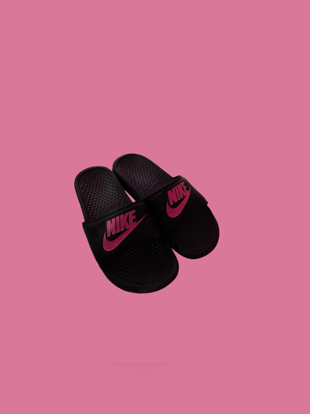 Black and pink Nike slides